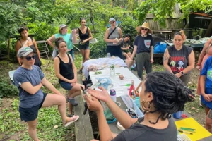 West Philly Urban Oasis group listening to speaker outdoors